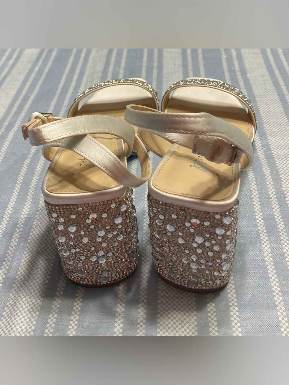 Betsey Johnson “Darbi” silver satin heels with rhinestone details.